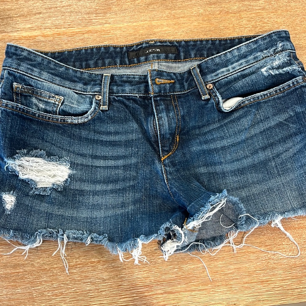 Distressed ripped Joes dark blue Jean shorts. Size 29